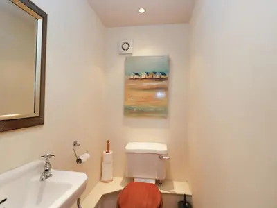 a bathroom with a toilet and a sink at The Old Barn in Hereford