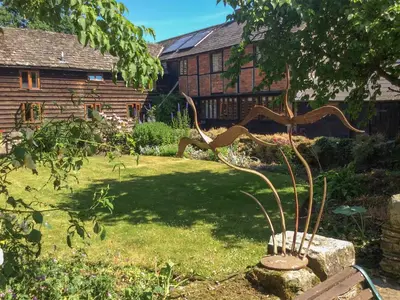 a metal sculpture of a tree in a garden at The Granary in Hereford