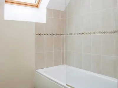 a bathroom with a bath tub and a toilet at Southdown in Much Wenlock