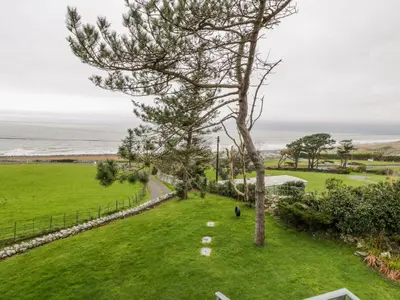 an aerial view of a lawn with the ocean in the background at Hendre Wylan in Barmouth