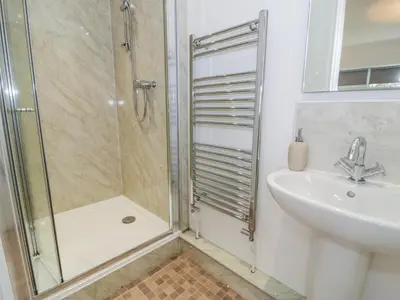 a bathroom with a shower and a sink at Hendre Wylan in Barmouth