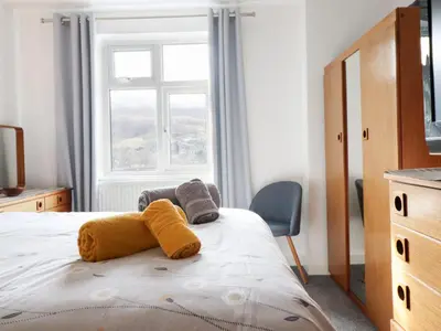 a bedroom with a bed with towels on it at Arnant in Dolgellau