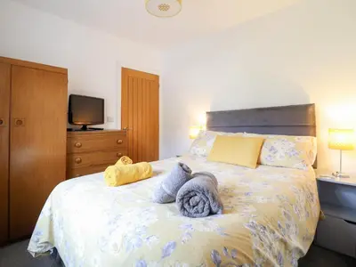 a bedroom with a bed with towels on it at Arnant in Dolgellau