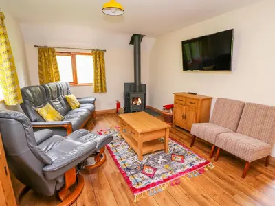 a living room with a couch and a tv at Pines Pitch in Knighton