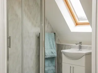 a bathroom with a sink and a skylight at Ragleth Place Lodge in Church Stretton