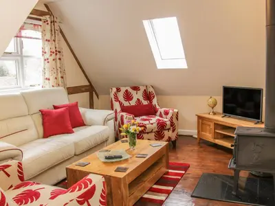 a living room with a couch and a tv at Ragleth Place Lodge in Church Stretton