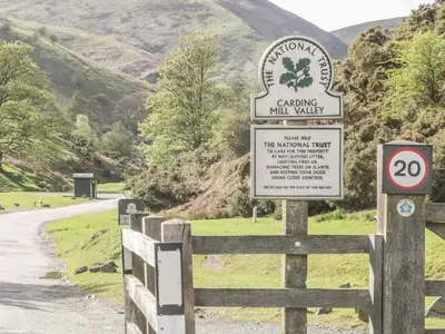 a sign on a fence next to a road at Ragleth Place Lodge in Church Stretton