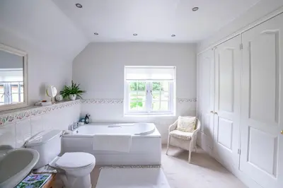a white bathroom with a tub and a toilet and a sink at Pelham Grove in Shrewsbury