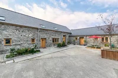 an exterior view of a stone building with a courtyard at 4 Bed in Bala oc-bow66 in Bala
