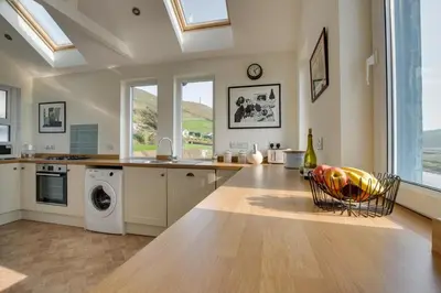 a kitchen with a sink and a washing machine at 3 Bed in Aberystwyth oc-bow115 in Aberystwyth