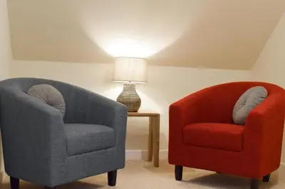 two chairs sitting next to a table with a lamp at 3 Bed in Machynlleth oc-bow91 in Penegoes