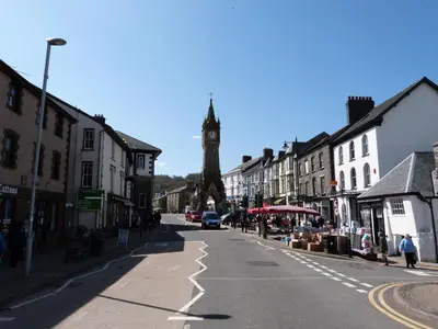 a city street with a clock tower in the distance at 3 Bed in Machynlleth oc-bow91 in Penegoes