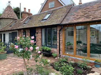 a house with a conservatory with windows and flowers at The Folly in Ludlow