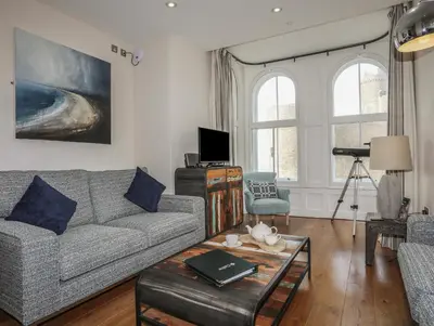 a living room with a couch and a table at Harlech Apartments - Branwen in Harlech