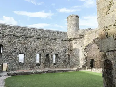 a large brick building with a chimney on it at Harlech Apartments - Bendigeidfran in Harlech