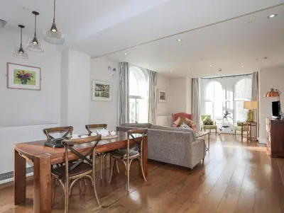 a living room with a table and a couch at Harlech Apartments - Bendigeidfran in Harlech