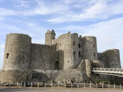 a large castle with two towers and a bridge at Harlech Apartments - Matholwch in Harlech