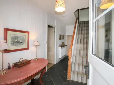 a hallway with a wooden table in a room at Big House in Llandecwyn