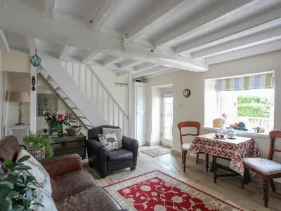 a living room with a table and chairs at Little House in Llandecwyn