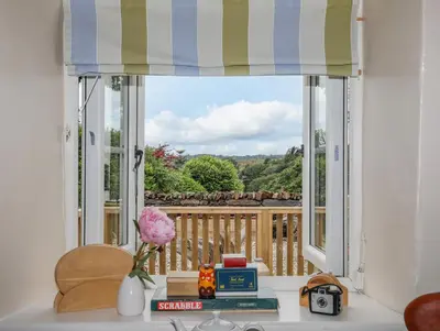 a window with a view of a deck at Little House in Llandecwyn
