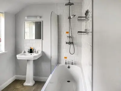 a bathroom with a tub and a sink and a shower at Brynich Villa in Brecon