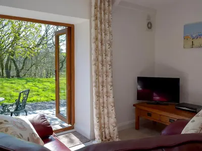 a living room with a sliding glass door at Hen Llaeth - Uk11209 in Cwrt-newydd