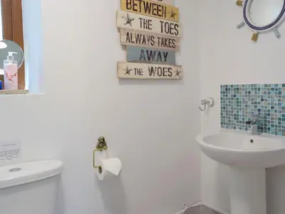 a bathroom with a sink and a toilet and a mirror at Hen Llaeth - Uk11209 in Cwrt-newydd