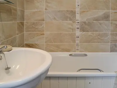 a bathroom with a white tub and a sink at Powis Castle View in Forden