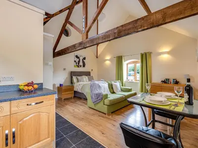 a kitchen and living room with a bed and a table at The Dairy - Uk10957 in Burlton