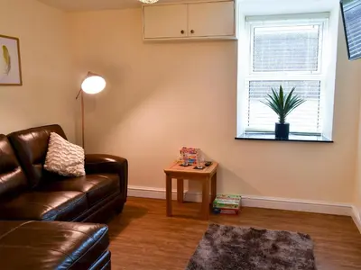 a living room with a couch and a table at Tyddyn Eli in Llangwm
