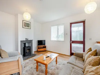 a living room with two couches and a coffee table at Cambrian Mountain View in Llanafan-fawr
