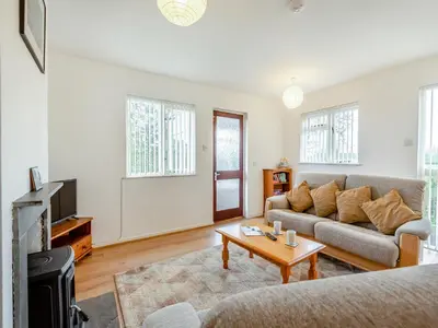a living room with a couch and a coffee table at Cambrian Mountain View in Llanafan-fawr