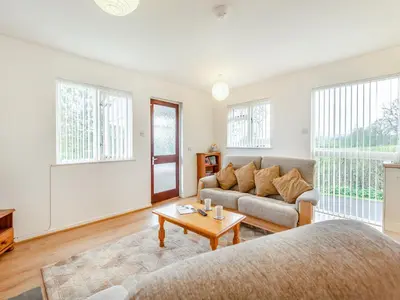 a living room with a couch and a table at Cambrian Mountain View in Llanafan-fawr