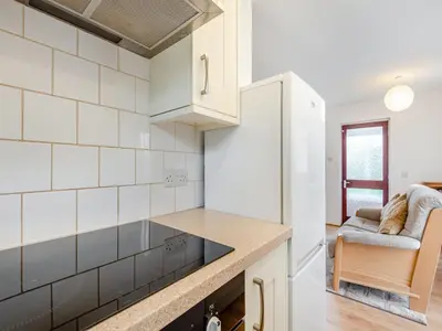 a kitchen with white tiled walls and a counter top at Cambrian Mountain View in Llanafan-fawr