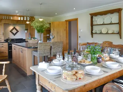 a table with plates of food on it in a kitchen at Maes Y Bryn Farmhouse in Llanwrda