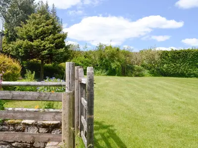 a wooden fence with a field behind it at Mountain View-Uk11825 in Llandefaelogfâch