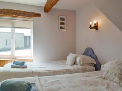 a bedroom with two beds and a window at Mountain View-Uk11825 in Llandefaelogfâch