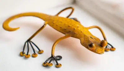 a small toy lizard on a white surface at Magnolia Cottage in Church Stretton