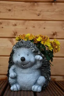 a statue of a teddy bear holding a bouquet of flowers at Long Wood Lodges in Knighton
