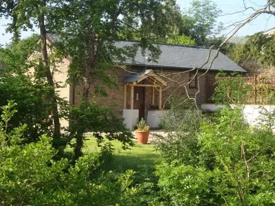 a small brick house with a yard with trees at River Cottage@Cwm Mill - Riverside Family Holidays in the Black Mountains in Hereford