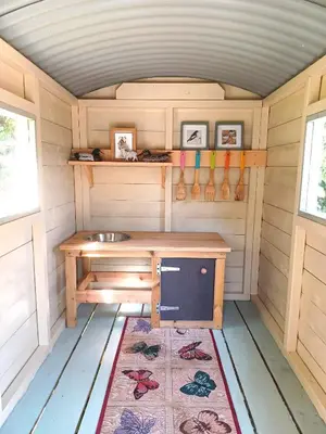 a small kitchen in a tiny house at River Cottage@Cwm Mill - Riverside Family Holidays in the Black Mountains in Hereford