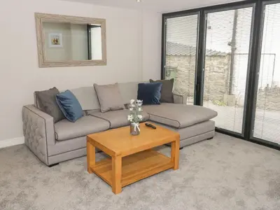 a living room with a couch and a coffee table at The Blue Lion in Cynwyd