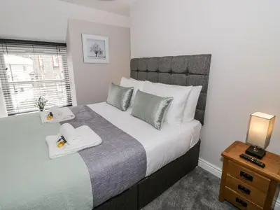 a bedroom with a large bed with two towels on it at The Blue Lion in Cynwyd