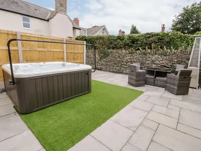 a backyard with a hot tub and green grass at The Blue Lion in Cynwyd