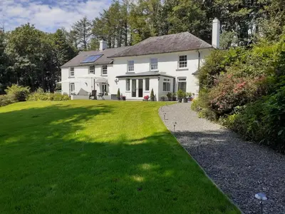 a large white house with a grass yard at Rhydyfran House Aberaeron, Lampeter, West Wales, Ceredigion in Lampeter