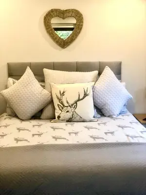 a bed with pillows with a picture of a deer on it at 49 Irfon Lodge in Builth Wells