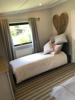 a bedroom with a bed with a large window at 49 Irfon Lodge in Builth Wells