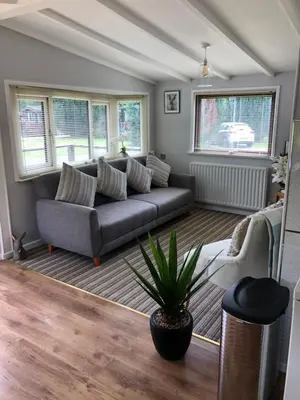 a living room with a couch and a plant at 49 Irfon Lodge in Builth Wells