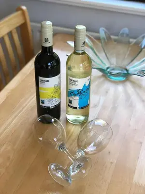 two wine glasses sitting on a wooden table at 49 Irfon Lodge in Builth Wells
