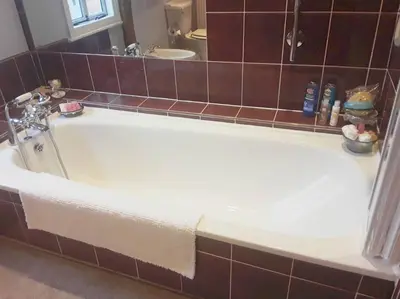 a large white bath tub in a bathroom at THE RETREAT in Hereford